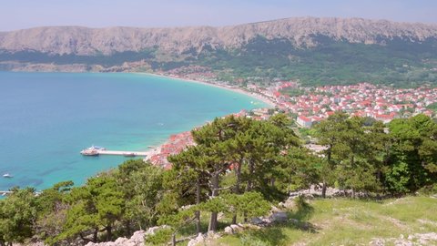 Aerial view of the city Baska on a sunny day. Location place Krk island, Kvarner gulf, Primorsko-Goranska Zupanija, Croatia, Europe. Cinematic shot. Filmed UHD 4k video. Discover the beauty of earth.