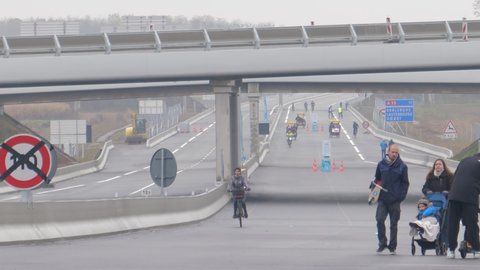 Vendenheim, France - Circa 2021: Large group of visitors - Open to pedestrians Vinci toll road gates during launch day of the Contournement Ouest de Strasbourg A 355 highway