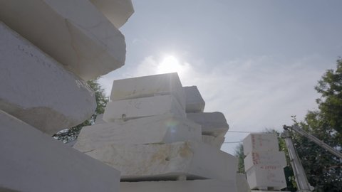 Heap Of Stone Blocks At Makrana Marble Manufacturing Against Sunny Sky. Low Angle