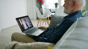 Senior man sitting on sofa and having video call with his doctor. - Powered by Shutterstock - Get 15% off with code: PIKWIZARD15