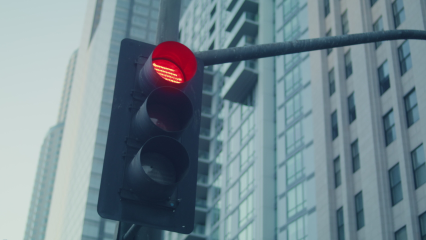 Traffic light change color on big city crossroad. Streetlight regulate traffic on megapolis highway closeup. Green red lights warning drivers on street. Modern technology in safety town life. | Shutterstock HD Video #1086688682