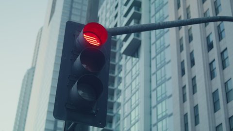 Traffic light change color on big city crossroad. Streetlight regulate traffic on megapolis highway closeup. Green red lights warning drivers on street. Modern technology in safety town life.