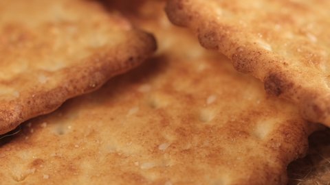 circle crackers with salt. Close up. Rotating cracker cookies background. Tasty food. Beautiful round crackers on canvas