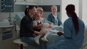 Healthcare specialist doing check up visit with patient and his family in hospital ward. Medical nurse giving assistance and support to elder man with illness to help with recovery. - Powered by Shutterstock - Get 15% off with code: PIKWIZARD15