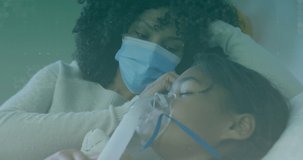 Animation of medical icons over african american mother and daughter wearing face mask. global medicine, healthcare and technology during covid 19 pandemic concept digitally generated video.