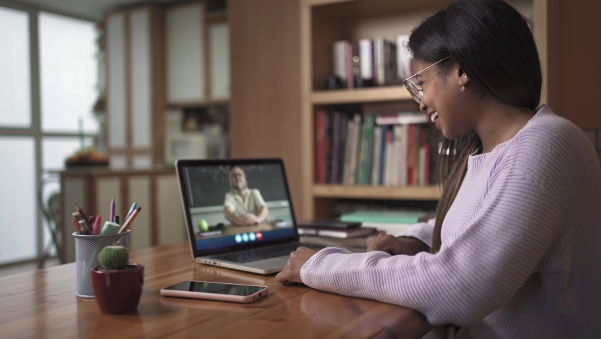 Female Black Latin Student learning watching video call with University School Teacher from home. Online Education Royalty-Free Stock Footage #1086697100