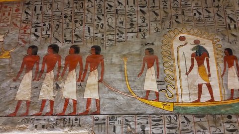 Luxor, Egypt - November 2021: Turists in Corridor with ancient Egyptian inscriptions and a tomb. The Valley of the King tomb KV16. Rameses I.