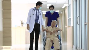 Footage B roll of blurred video of elderly man in wheelchair and care helper in modern hospital.