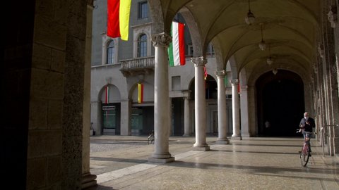 Bergamo. Lombardy. Italy. 10-31-2021. Man walks on the porch with mask. City of Bergamo. Largo Porta Nuova. Slow motion 4K