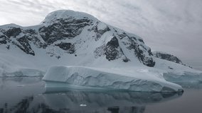 Antarctica. Sea mountains and large icebergs reflecting in the water. Fantastic wonderful amazing video. Life of nature, seaside and mountains.