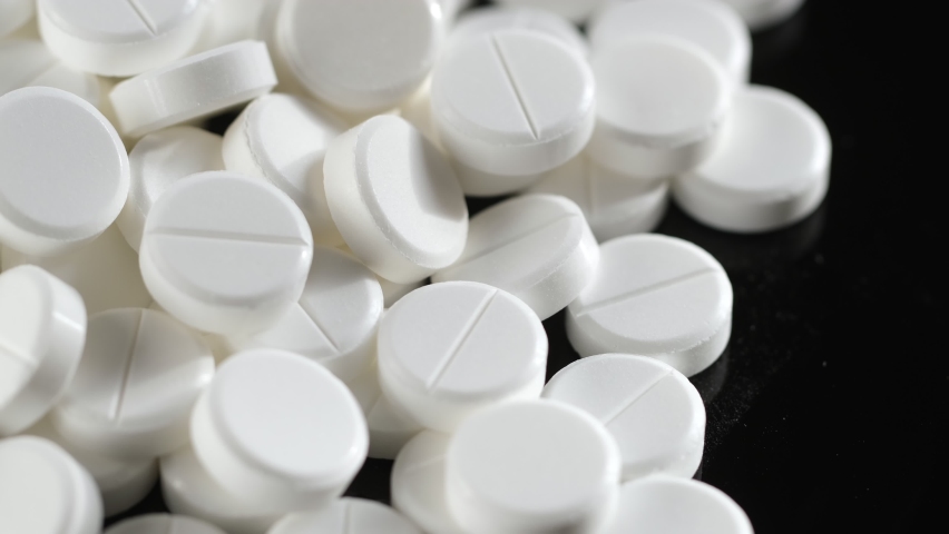 White medical pills rotating closeup. Pills and drugs. Pharmaceutical Industry. The medicine concept. 4K