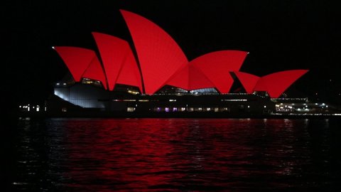 Sydney, NSW, Australia - February 2nd, 2022: Sydney Opera House was lit up in red from about 8:40pm to celebrate the lunar new year.