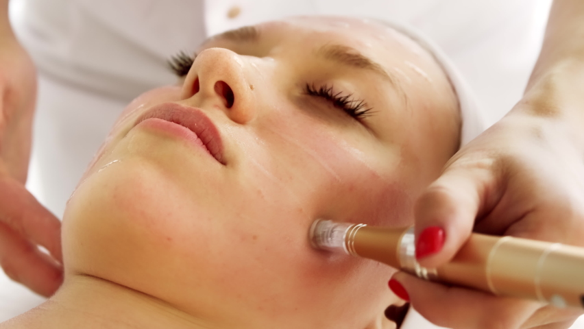 Beautician cosmetologist doing procedure fractional microneedle mesotherapy with Dermapen. Hardware cosmetology in clinic salon for client.  | Shutterstock HD Video #1086710408