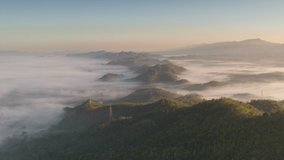 Hyper lapse video 4k motion, Aerial view Beautiful of morning scenery Golden light sunrise And high voltage power the mist flows on high mountains. Pang Puai, Mae Moh, Lampang, Thailand. 