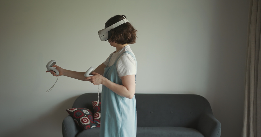 Woman exploring cyberspace with virtual reality headset | Shutterstock HD Video #1086714434