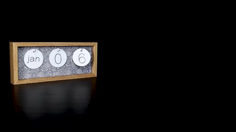 A wooden calendar block showing the date January 6th with a mans hand putting on and taking off the metal discs with the date and month on them, filmed in 8k quality 