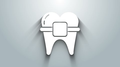 White Teeth with braces icon isolated on grey background. Alignment of bite of teeth, dental row with with braces. Dental concept. 4K Video motion graphic animation.