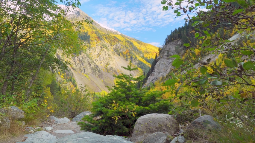 A couple of young men with backpacks alone in the autumn mountains. They go to and enjoy the beautiful scenery of the highlands in autumn. Hiking. Georgia. A lonely journey.