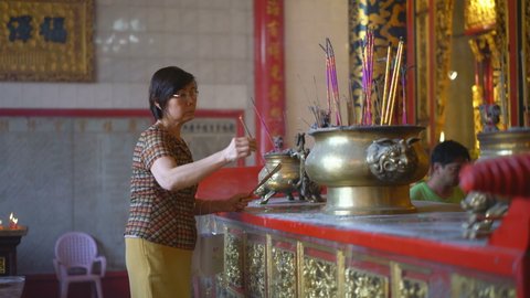 YANGON, MYANMAR - 4TH FEBRUARY, 2019: Pilgrims in the Kheng Hock Keong Temple, Yangon, Myanmar, Asia