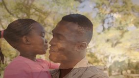 Animation of trees over happy african american male soldier carrying his daughter. patriotism and celebration concept digitally generated video.