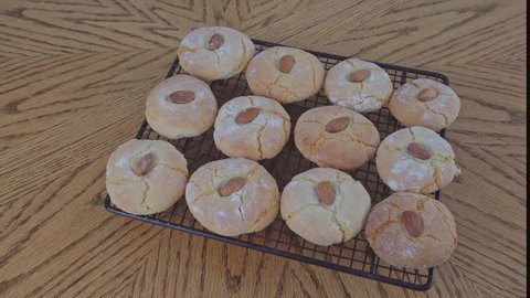 Baked cookies appear on the cooling rack put it on the table and take it. The process of making gluten-free almond flour cookies. Step by step. Homemade baking cookies. Biscotti di mandorla siciliani.