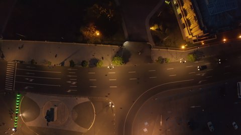 Aerial view of night streets in downtown Bucharest, Romania, with bright night illumination. cars drive through the streets of the night city. Wide shot with smooth cinematic drone motion. 4k footage