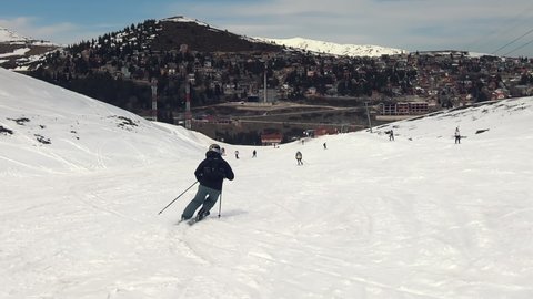 Tracking shot of professional skier skiing on slopes