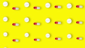 Colorful pattern of pills and capsules on yellow background with shadows. Seamless pattern with tablets. Medical, pharmacy and healthcare concept. Closeup. 4K video motion