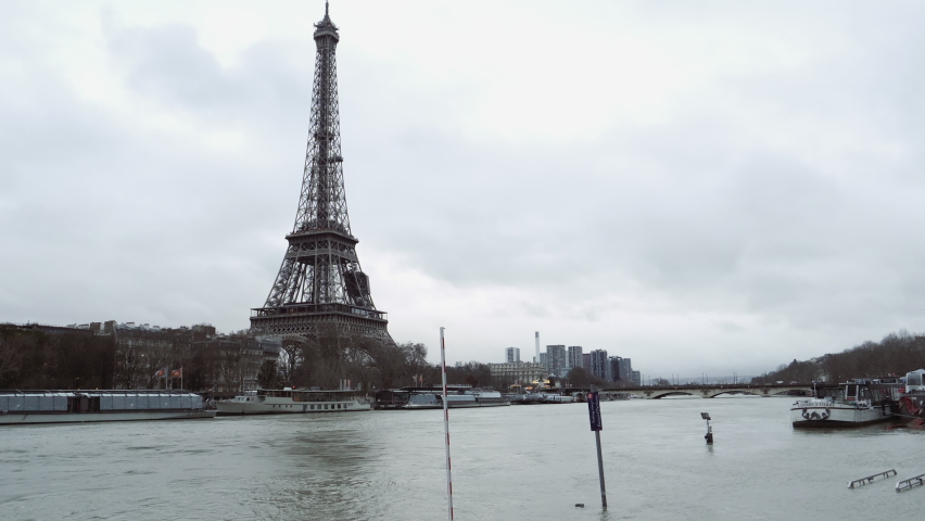 Paris, France - Circa 2019: Paris flooding - record rainfall hits French capital with Seine river getting higher - Eiffel tower in background surveilling the whole city