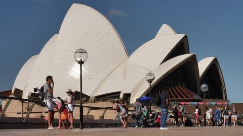 SYDNEY, NSW, AUSTRALIA. JANUARY 26 2022. A family relaxing outside Sydney Opera House on Australia Day, slow motion.