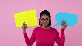 Cute young african american girl in pink clothes stands with posters for expression on a solid pink background. A place for advertising slogans