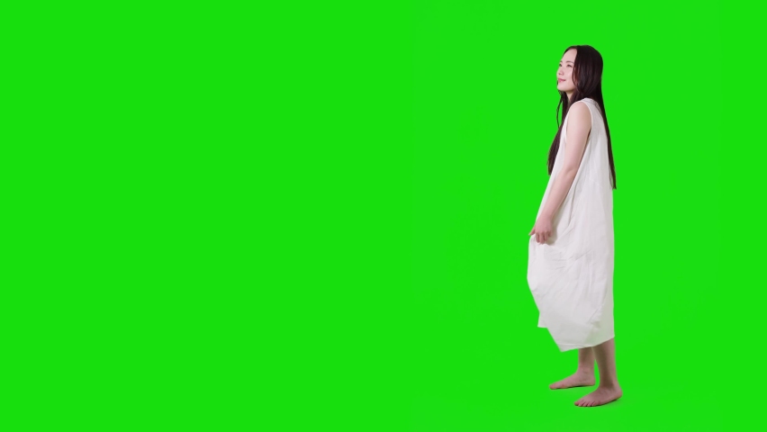 Young asian woman with white dress. Green background for chroma key composition.