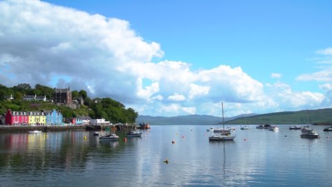 Several pleasure yachts are moored in the anchorage of the village of Mull in Scotland on the Tobermory Isle on a sunny day. Wide shot