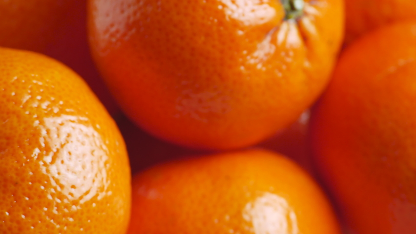 Fresh Mandarin orange - Tangerine rich with vitamins. Closeup shot with subtle rotating movement.