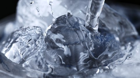 Стоковое видео: Super Slow Motion Detail Shot of Pouring Vodka on Ice Cubes at 1000 fps.