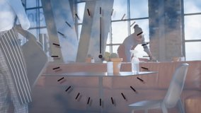 Animation of clock over diverse couple working in face masks. global networks, business and connections during covid 19 pandemic concept digitally generated video. - Powered by Shutterstock - Get 15% off with code: PIKWIZARD15