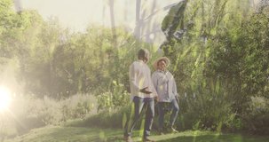 Video of lights over biracial senior couple walking in nature. national walk day, healthy lifestyle digitally generated video.