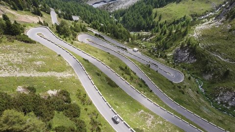 Aerial Top Down Drone View of the Stelvio Mountain Pass Road in Italy - Cars and Motor Driving the Hairpins Curves (Bends)