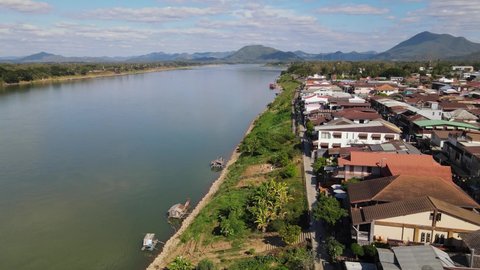 Reverse aerial footage of the Mekong river and partly Laos revealing mainly the Walking Street in Chiang Khan, Loei in Thailand.