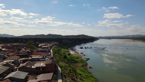 Ascending aerial footage of Chiang Khan at the Walking Street also revealing the Mekong River and Laos, Loei in Thailand.