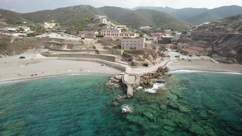 Aerial establishing shot of the bay and the beaches of a Cape Argentiera - former silver mines in Sardinia, Italy