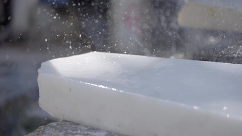 Water Spray On White Makrana Marble During Cutting Process. close up