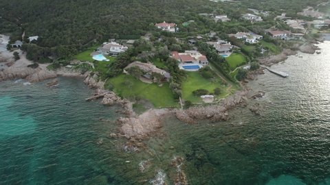 Aerial orbit over the residential area situated on the Emerald Coast near Porto Cervo, Sardinia, Italy.