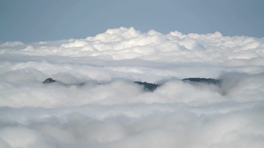 8K 7680x4320.Time lapse from mountain peak.High altitude.Accelerated cloud movements.Sea of clouds.Climate above the clouds.Landscape above cloud level.Like airplane window.Troposphere Stratosphere. Royalty-Free Stock Footage #1086756104