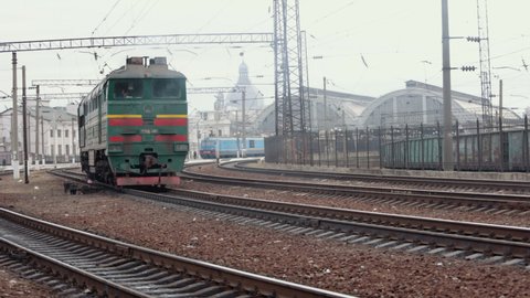 Old electric train moving by rail. Outdated design. Soviet electric train traveling. Transportation concept. Old diesel vehicle travels along the railway line. Suburban passenger transportation.