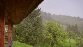 Rain flows down from the roof. Rainy weather, raindrops fall continuously. Footage of the forces of nature. Cinematic shot. Filmed in Full HD 1080p video. Slow motion clip 240 fps. Beauty of earth.