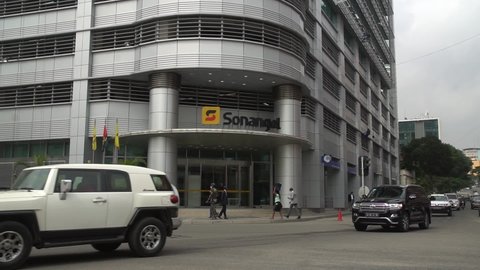 Luanda, Angola - June 16th 2021:Normal working day traffic scene with the facade of the headquarters building of the state oil company Sonangol in downtown Luanda, capital city of Angola, Africa