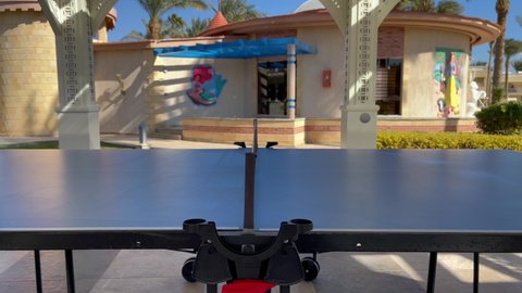 Table tennis game, close up. Feceless people plays ping pong outdoors. Hurghada, Egypt - January 2022