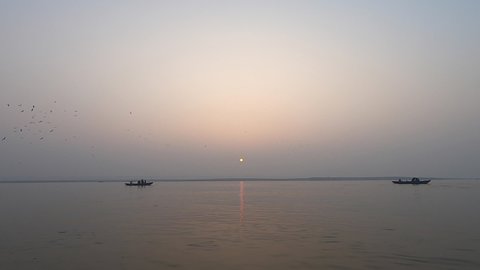 View of Ganges River with traditional boats at Sunrise. Varanasi, India