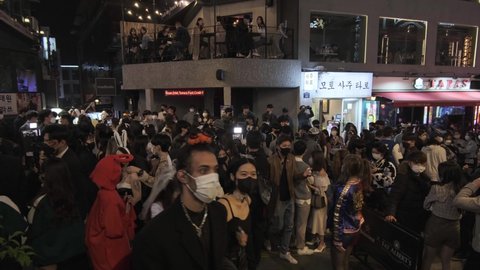 Seoul, South Korea - 2021 - huge crowd of Koreans and foreigners at intersection of Itaewon on Halloween during Covid-19